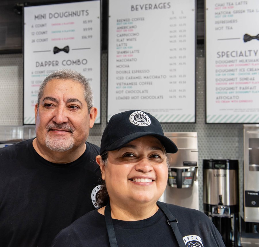 Melissa and Paul Shaffer, owners of Dapper Doughnut Arlington – Town North, behind the counter