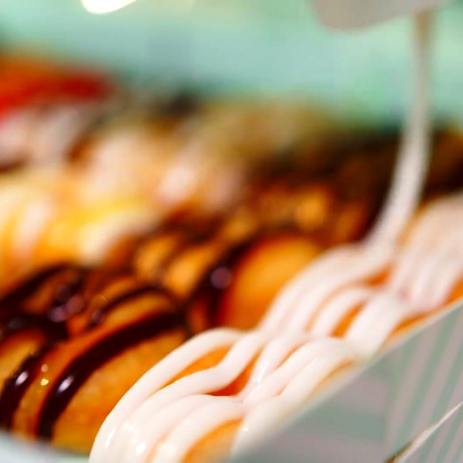 A doughnut being freshly decorated
